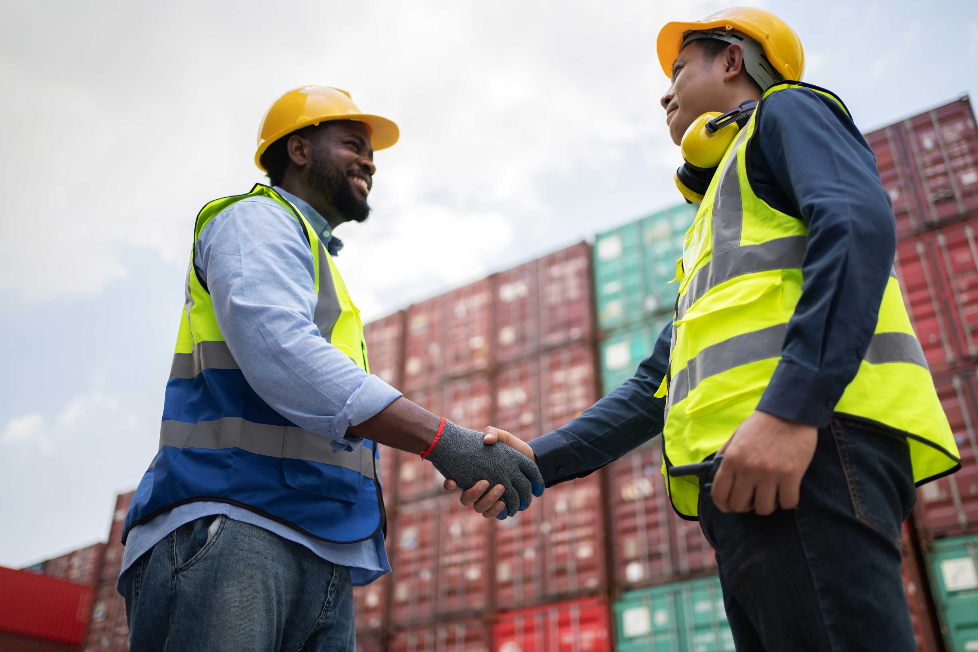 Two port workers shaking hands